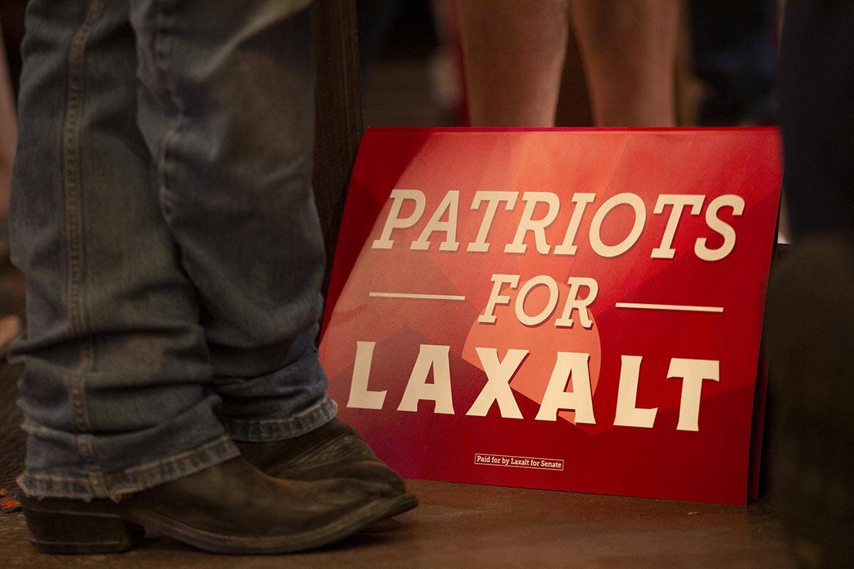 An attendee wears cowboy boots during a rally for Nevada Republican U.S. Senate candidate Adam ...