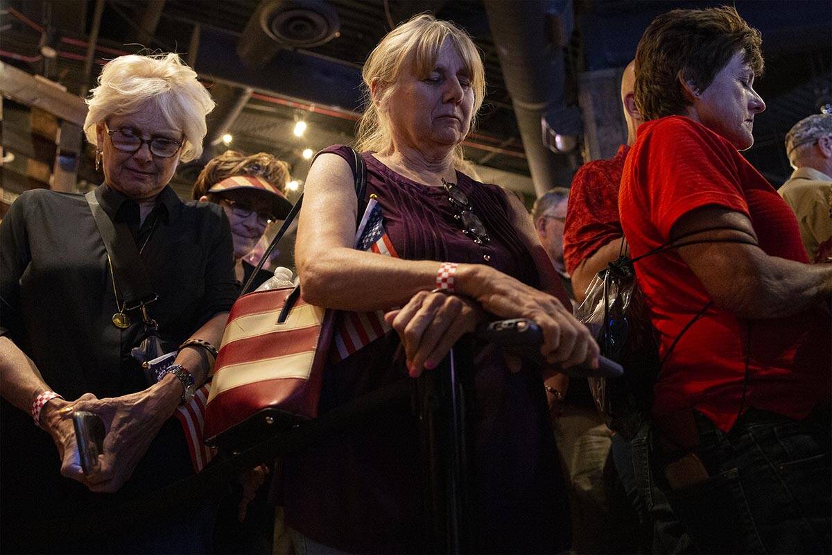 Linda Gelinger, left, Barbara Dicapua, and Penny Kaska, all of Las Vegas, pray during a rally f ...
