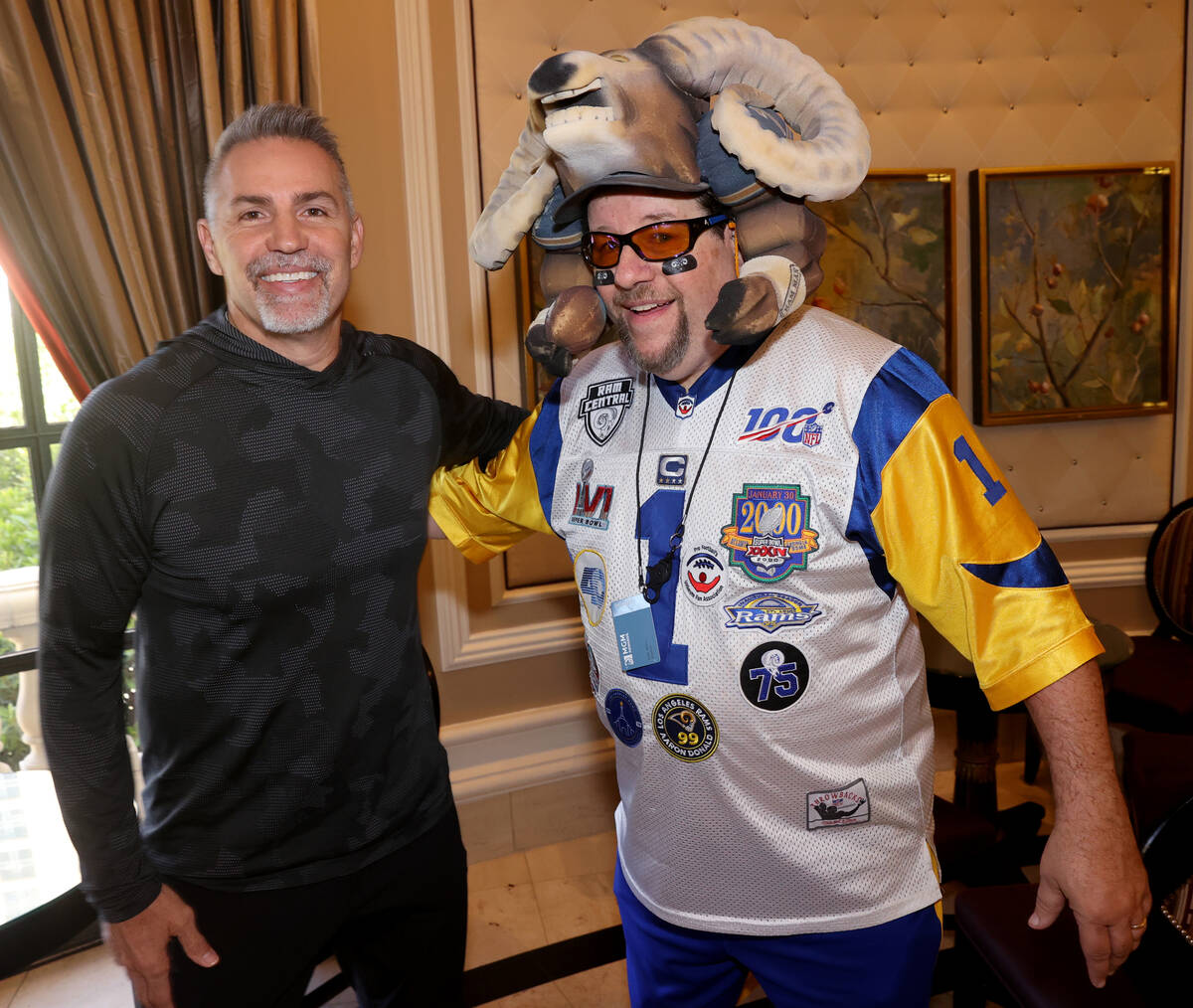 Karl “Rams Man” Sides of St. Louis poses with NFL great Kurt Warner at the Bellag ...
