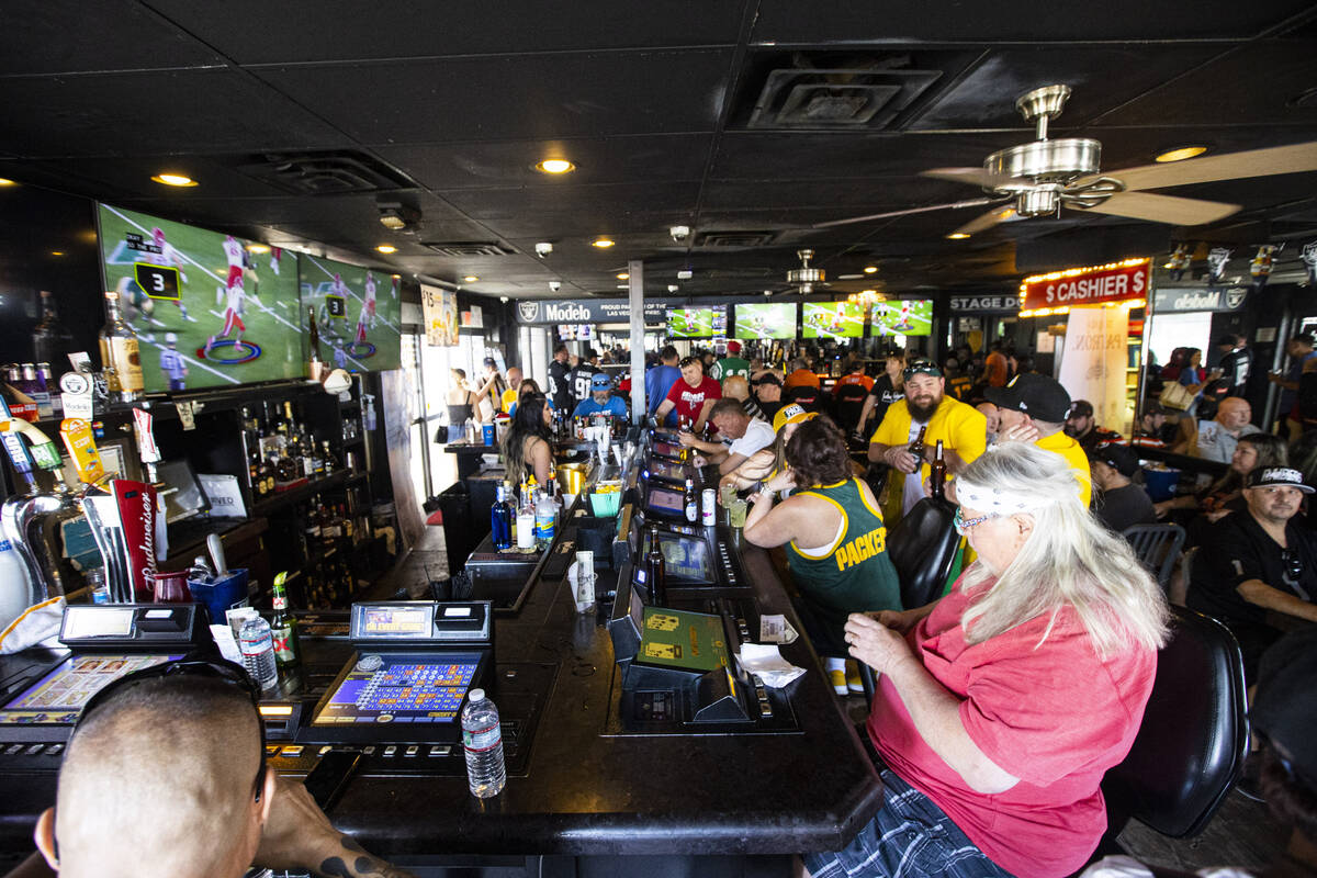 Football fans hang out at the Stage Door Casino during the first day of the NFL draft on Thursd ...