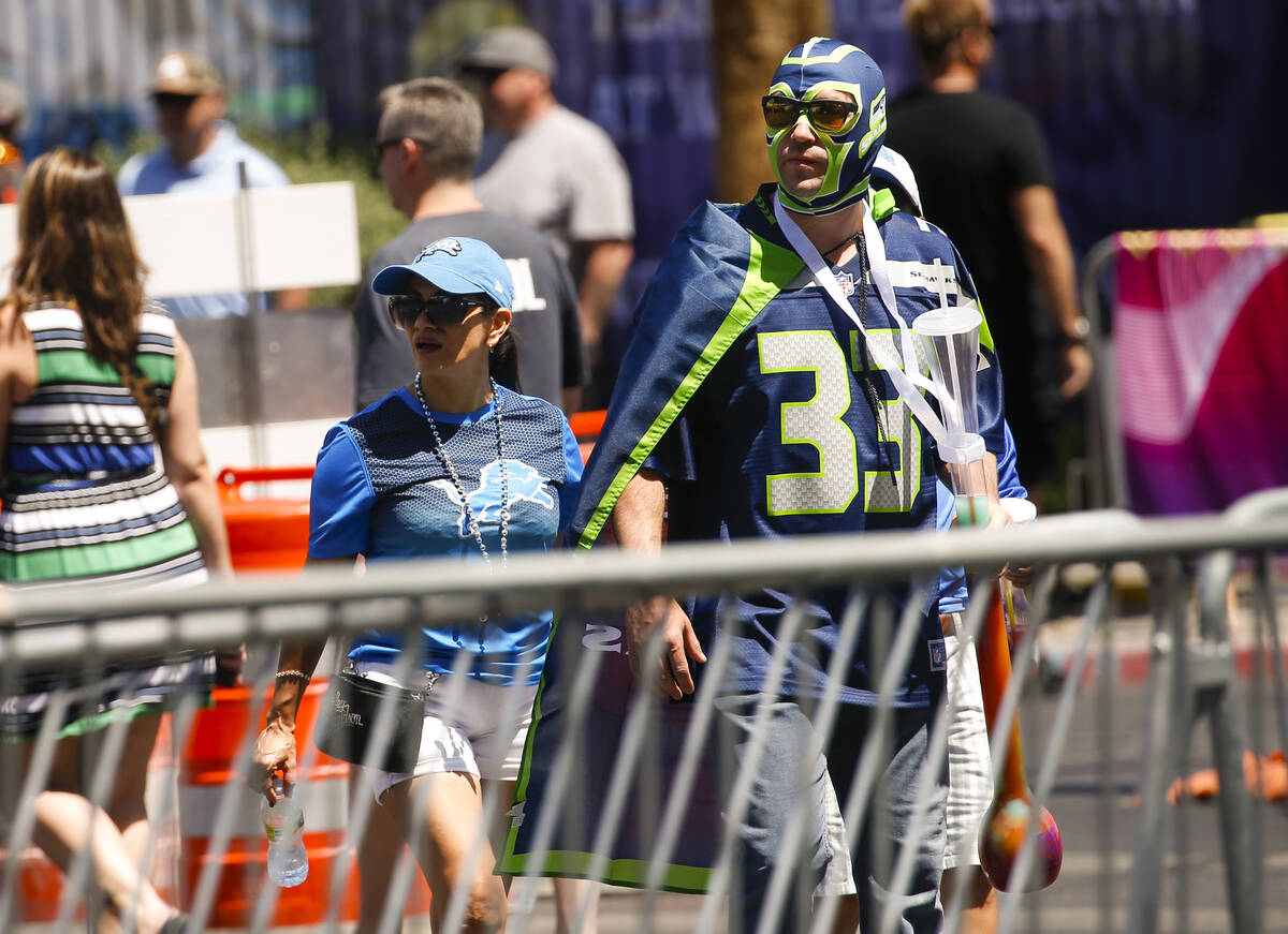 Football fans arrive for the first day of the NFL draft on Thursday, April 28, 2022, in Las Veg ...
