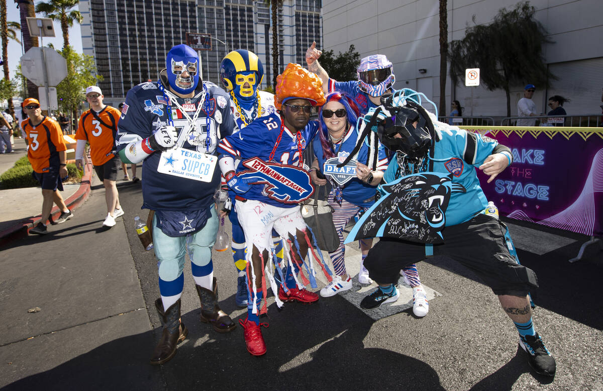 Members of Elite Super Fans poses for a picture during the first day of the NFL draft on Thursd ...