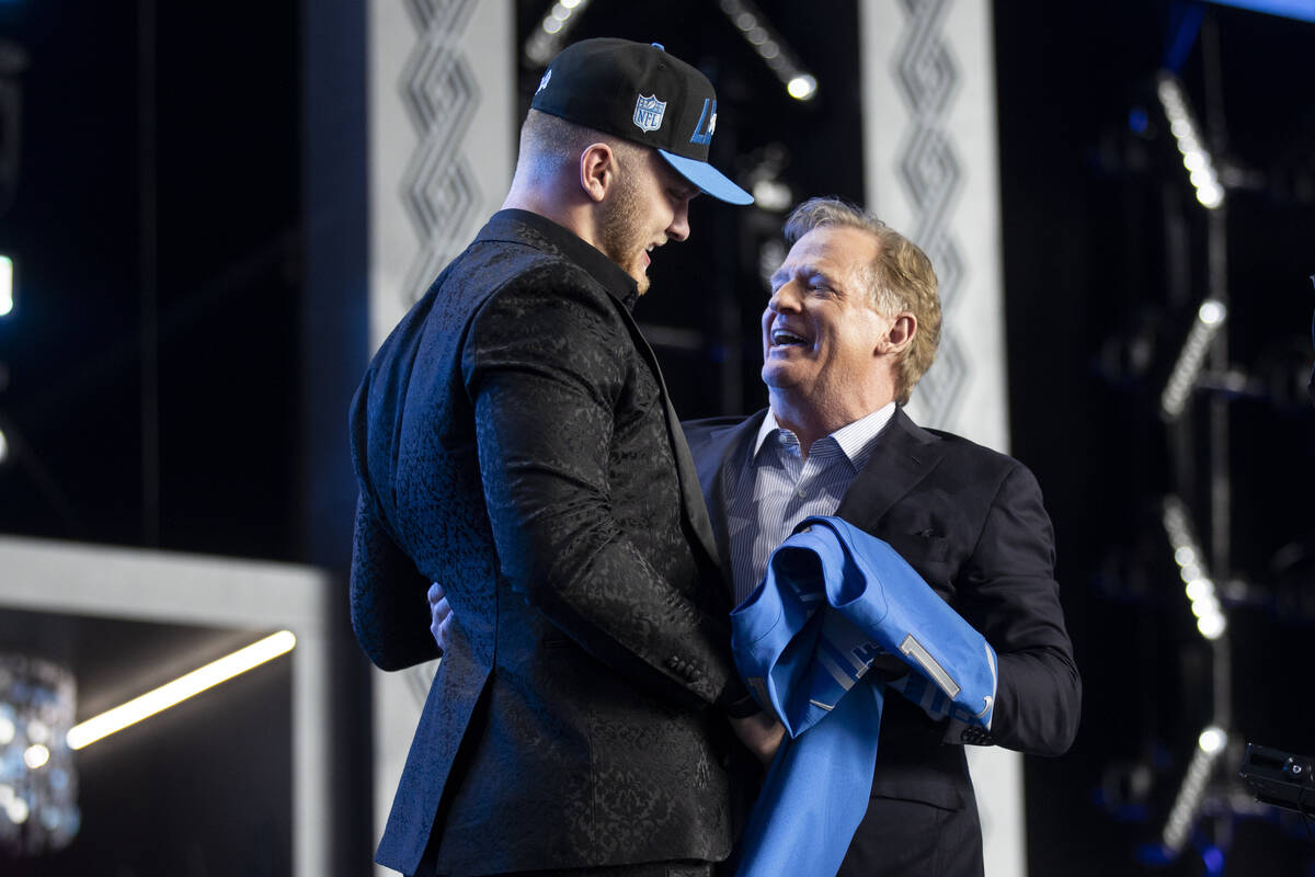 NFL Commissioner Roger Goodell, right, embraces Aidan Hutchinson, the Detroit Lions second pick ...