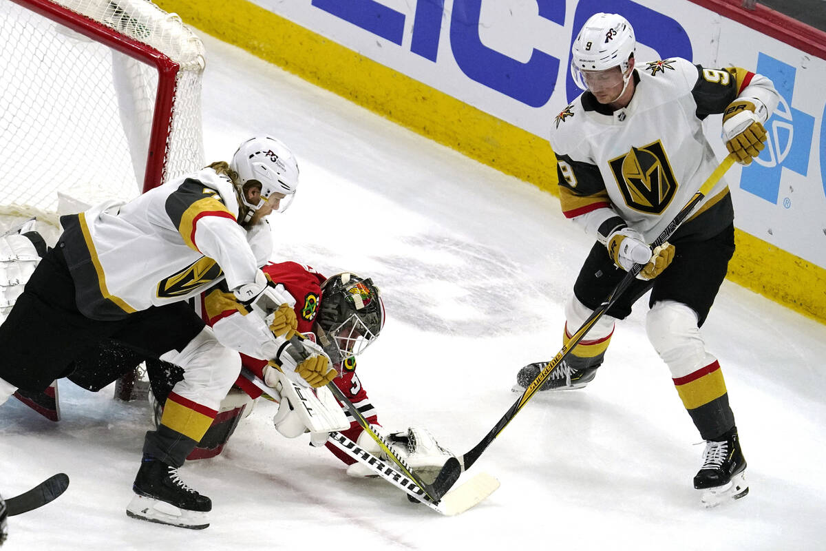 Chicago Blackhawks goaltender Kevin Lankinen, center, saves a shot against Vegas Golden Knights ...