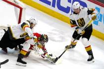 Chicago Blackhawks goaltender Kevin Lankinen, center, saves a shot against Vegas Golden Knights ...