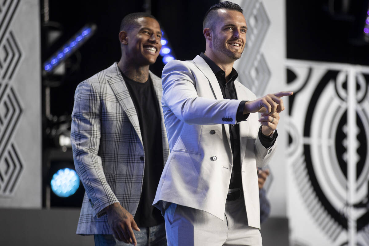 Raiders players Darren Waller and Derek Carr take the stage during the NFL Draft event in Las ...