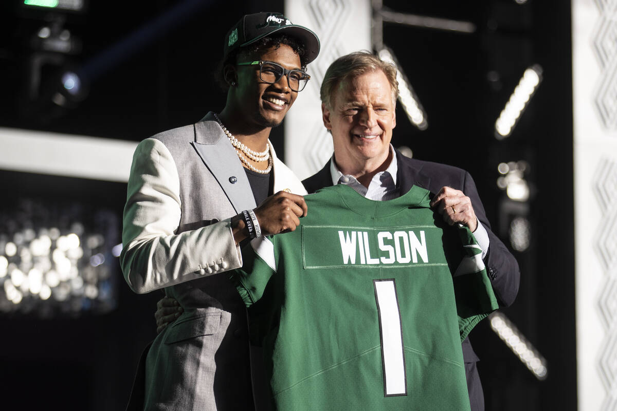 Ohio State wide receiver Garrett Wilson stands with NFL Commissioner Roger Goodell after being ...