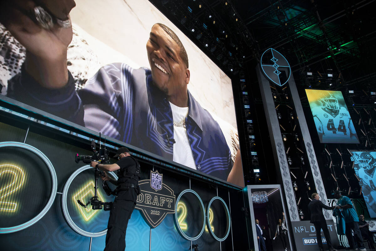 NFL Commissioner Roger Goodell, left, holds a Jacksonville Jaguars jersey after announcing Trav ...