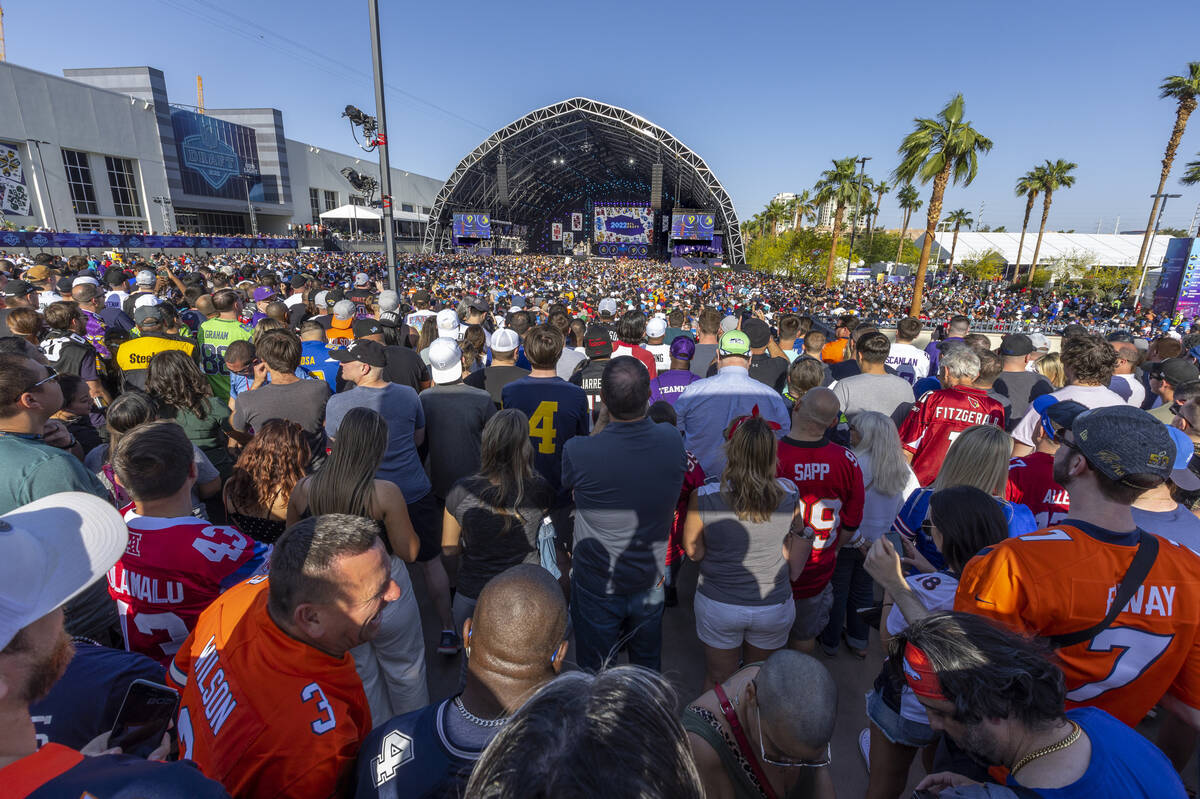 A crowd gathers to watch the start of the 2022 NFL Draft from the Draft Theater within the Draf ...