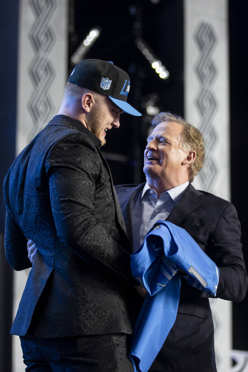 NFL Commissioner Roger Goodell, right, embraces Aidan Hutchinson, the Detroit Lions second pick ...
