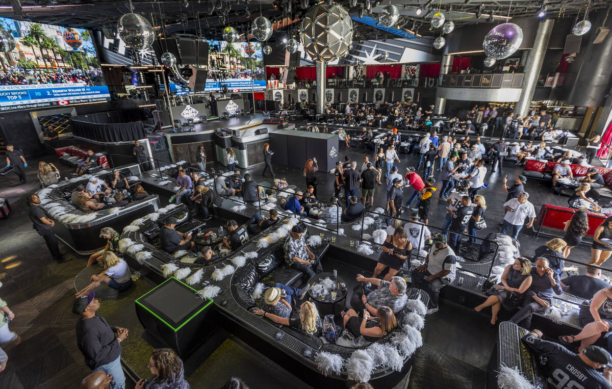 Attendees enjoy a Raiders draft party at Drai's Beachclub & Nightclub during the first day ...