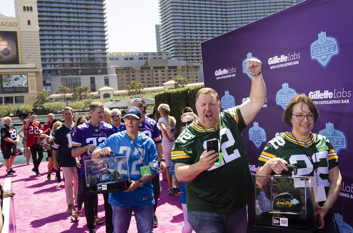Super fans walk onto the NFL Red Carpet Stage on Thursday, April 28, 2022, at the Bellagio Foun ...