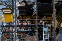 A liquor store owner looks at the damage to his shop caused by an explosion in Kyiv, Ukraine on ...