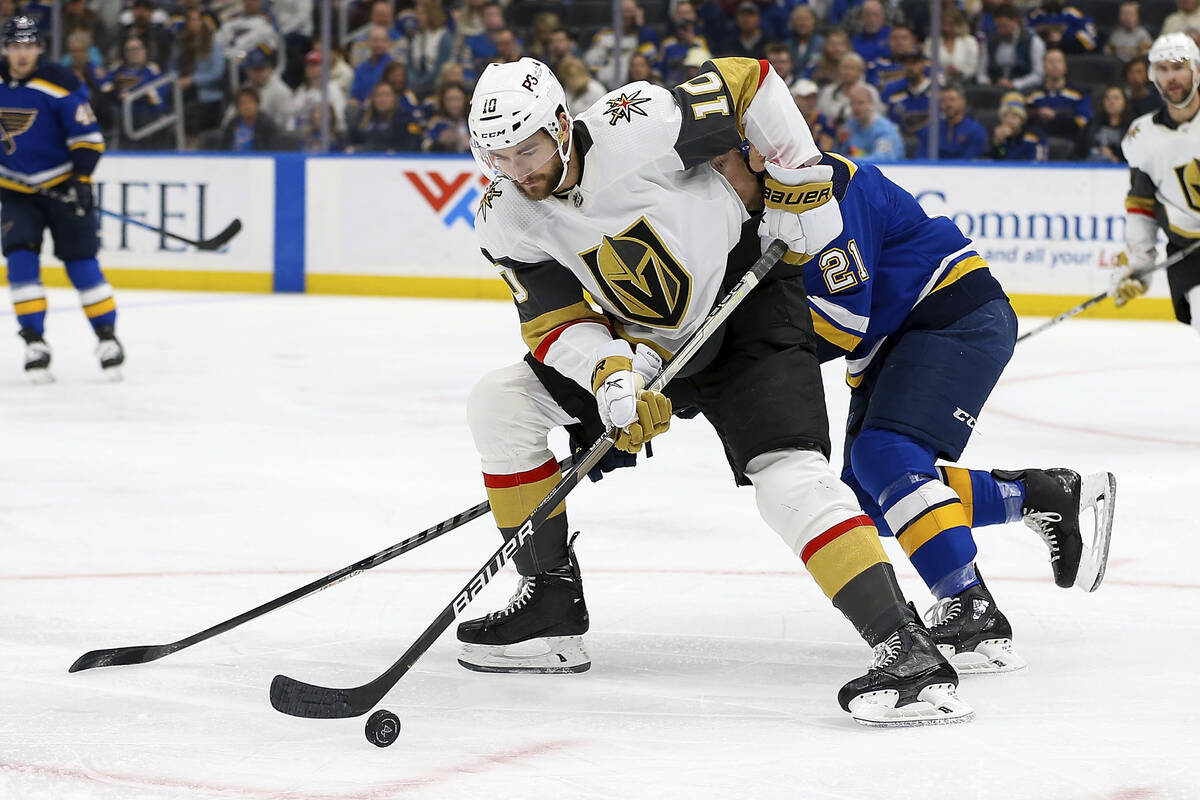Vegas Golden Knights' Nicolas Roy (10) controls the puck while under pressure from St. Louis Bl ...