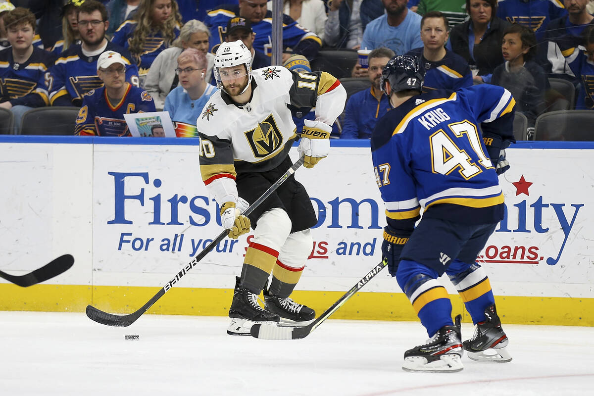 Vegas Golden Knights' Nicolas Roy (10) looks to pass the puck while under pressure from St. Lou ...