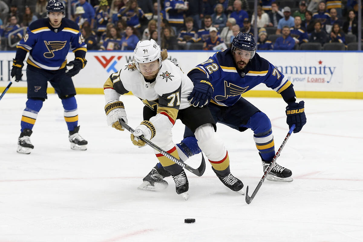 Vegas Golden Knights' William Karlsson (71) and St. Louis Blues' Justin Faulk (72) vie for cont ...