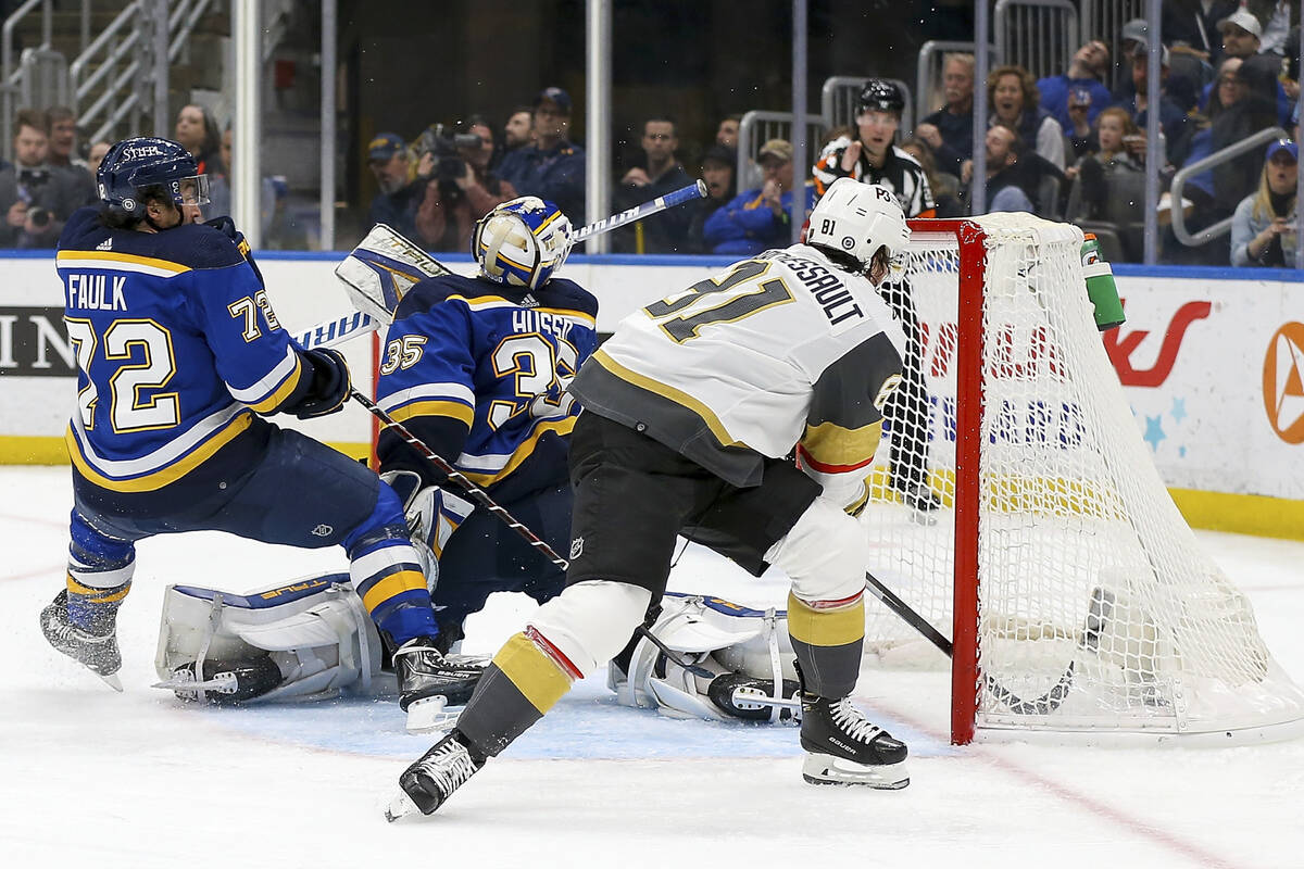 St. Louis Blues goaltender Ville Husso (35) and Justin Faulk (72) are unable to prevent Vegas G ...