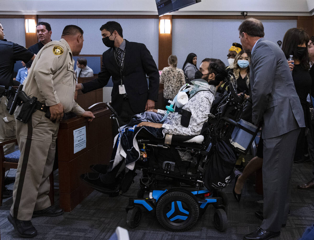 Metro officer Shay Mikalonis, center in a wheelchair, prepares to leave the courtroom after att ...