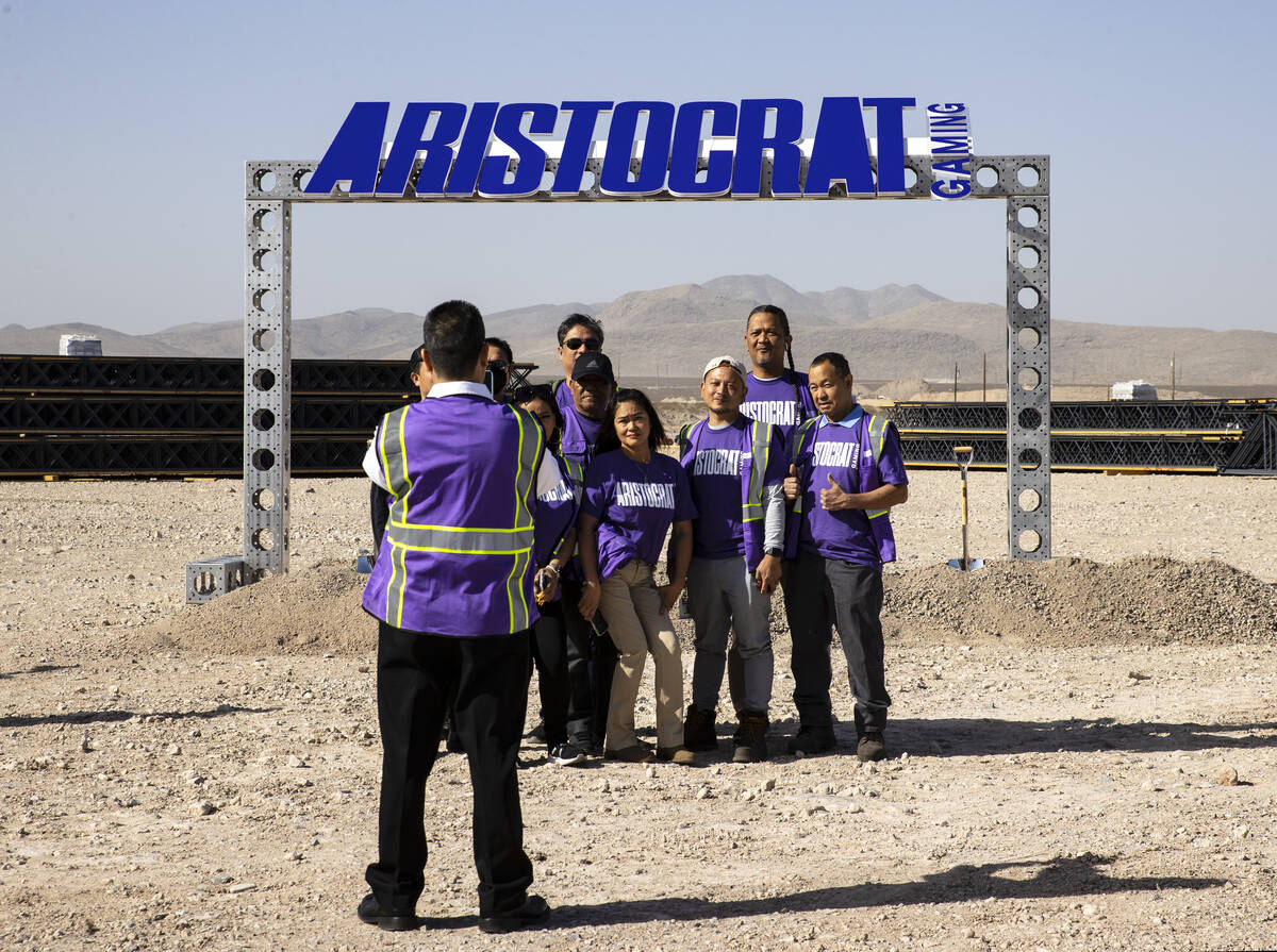 Aristocrat Gaming employees pose for a photo at the construction site of a new manufacturing pl ...