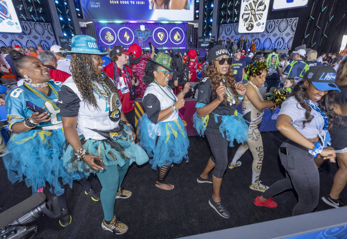 Fans dance together in the Draft Theater during the second day selections for the 2022 NFL draf ...