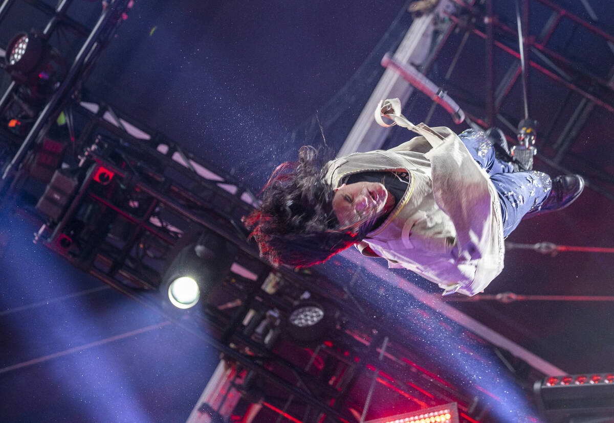 Illusionist Criss Angel hangs upside down while getting out of a straight jacket on the Draft T ...