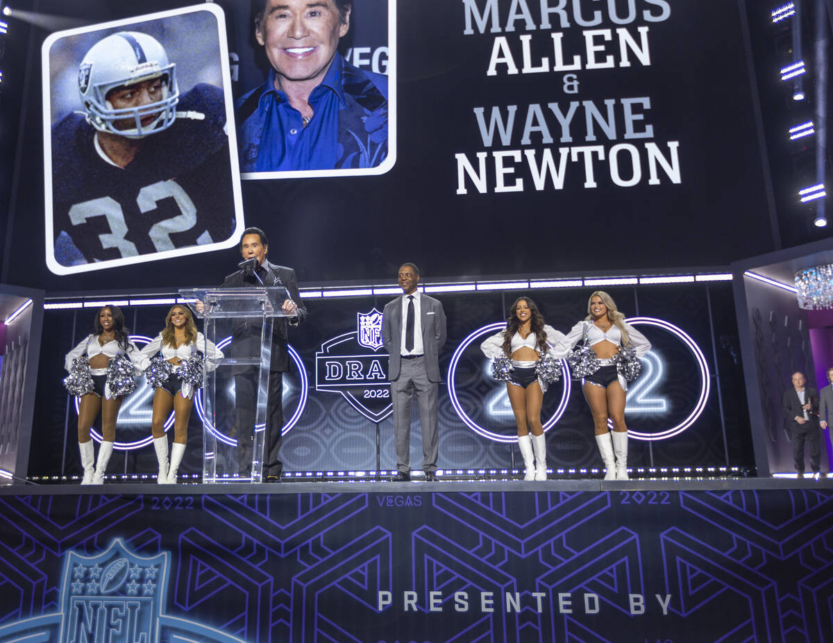 Marcus Allen and Wayne Newton announce 90th player selection at the Draft Theater during the se ...