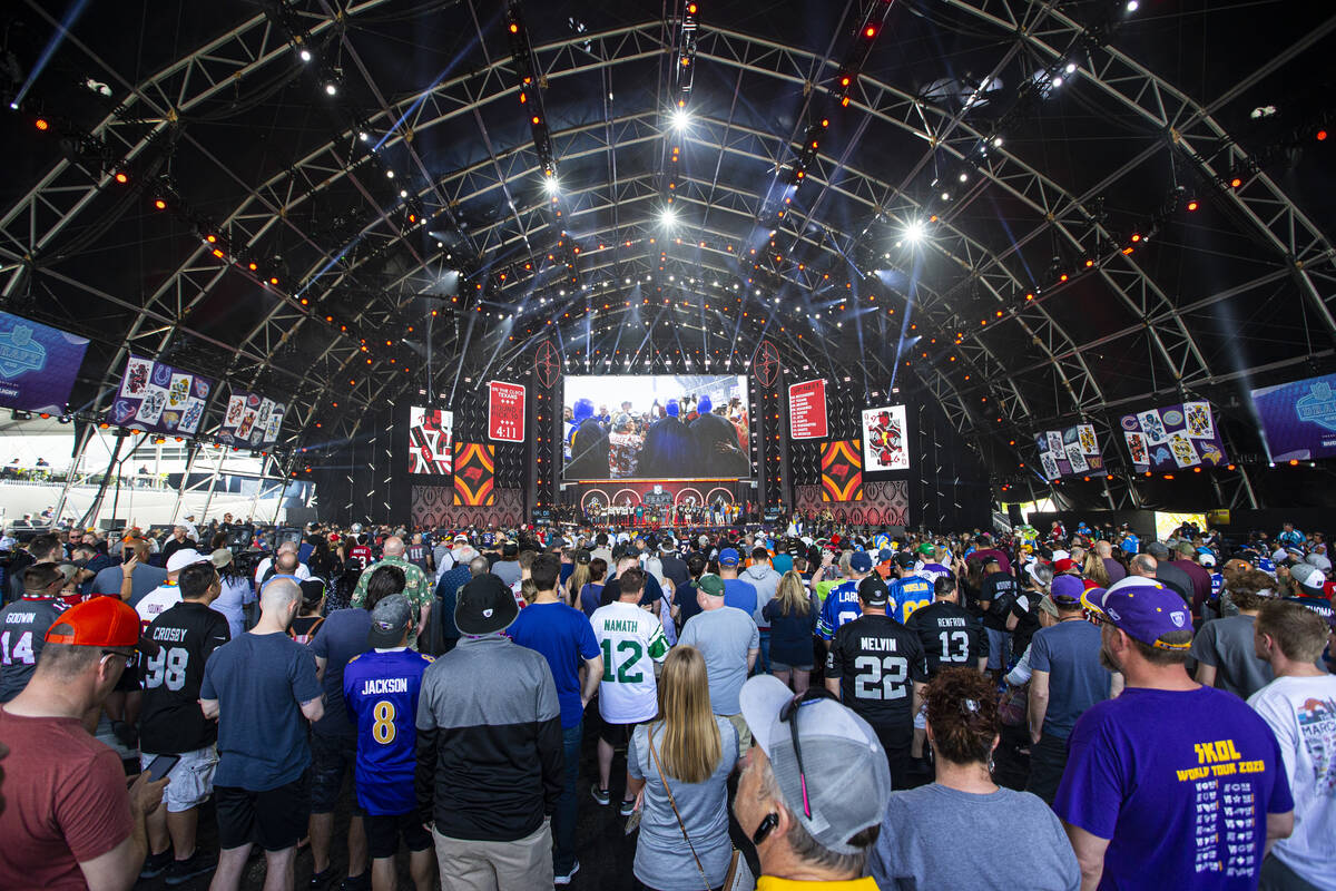 Fans watch as the fourth round of the NFL draft kicks off on the third day of the draft Saturda ...