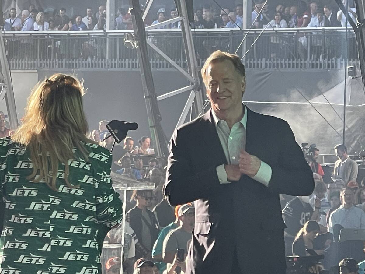 NFL Commissioner Roger Goodell shares a moment with a New York Jets fans on stage at the NFL dr ...