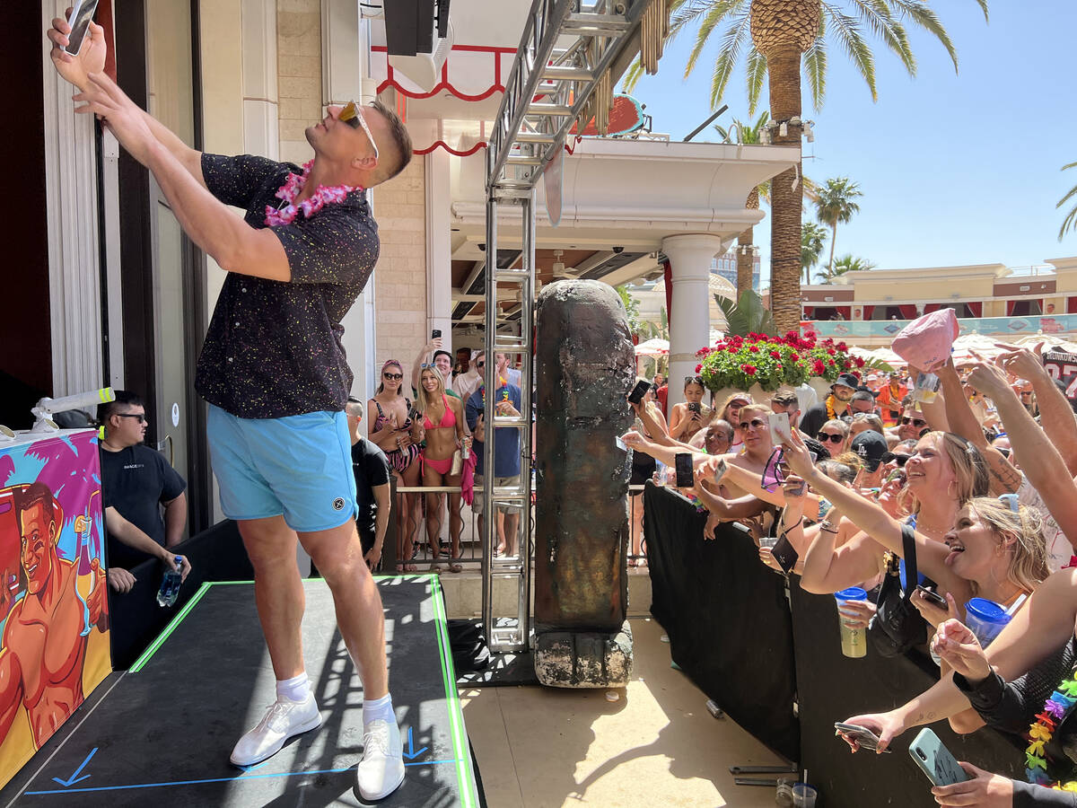 Rob Gronkowski takes a selfie with the crowd during Gronk Beach party at Encore Beach Club on t ...