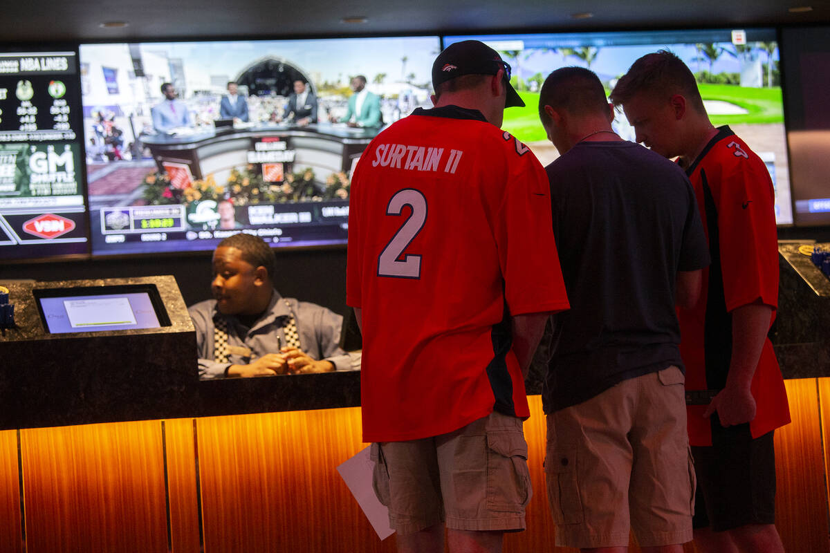Sports bettors wear NFL football jerseys while placing bets at Circa, Friday, April 29, 2022, i ...