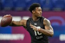 FILE - Liberty quarterback Malik Willis runs a drill during the NFL football scouting combine, ...