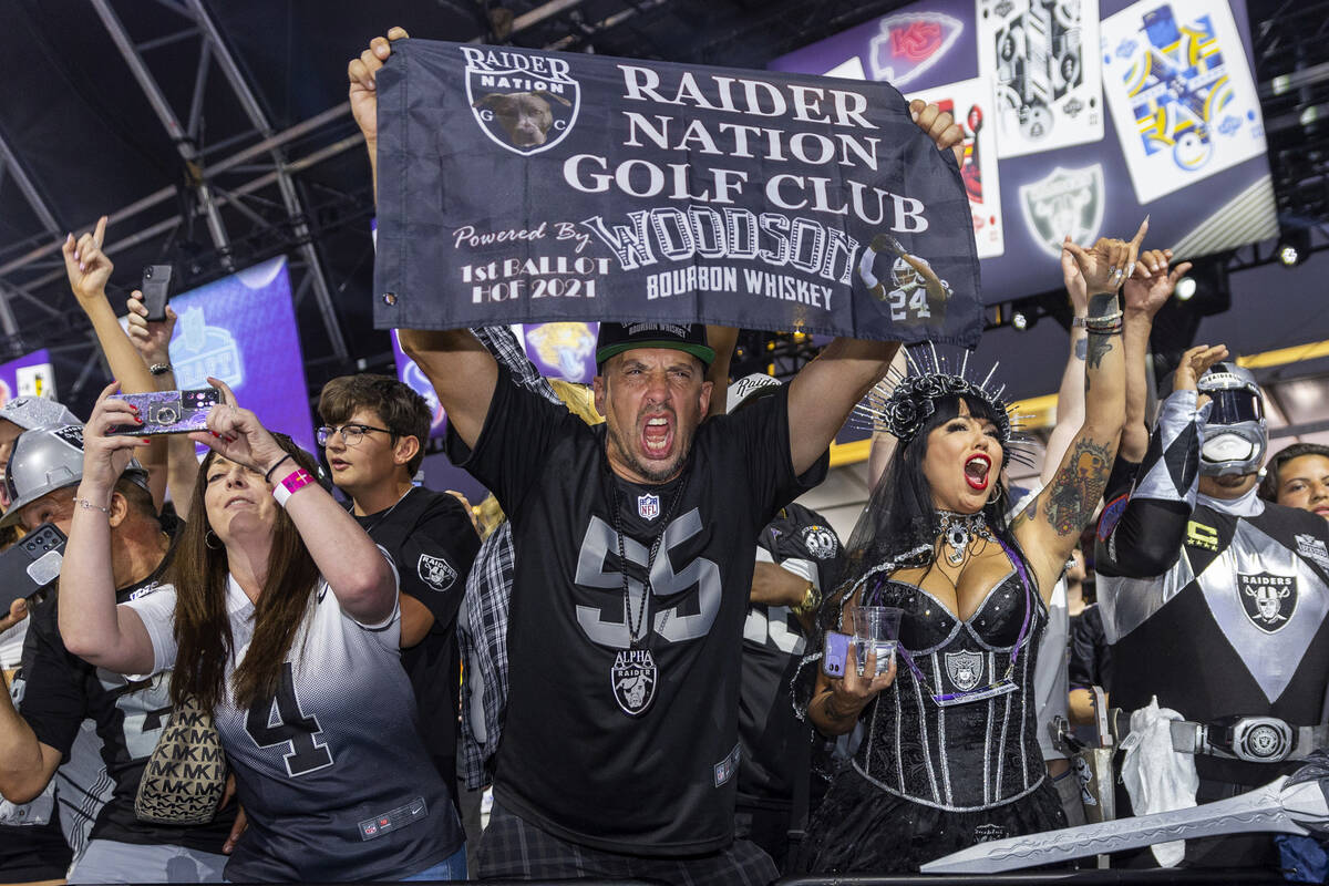 Raiders fans celebrate their 90th player selection at the Draft Theater during the second day s ...
