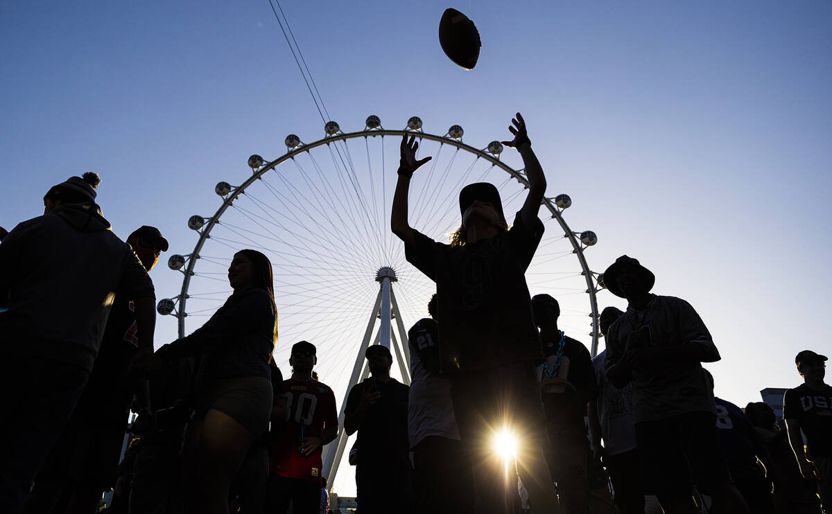 Fans socialize outside the NFL Draft Stage during day two of the NFL draft on Friday, April 29, ...