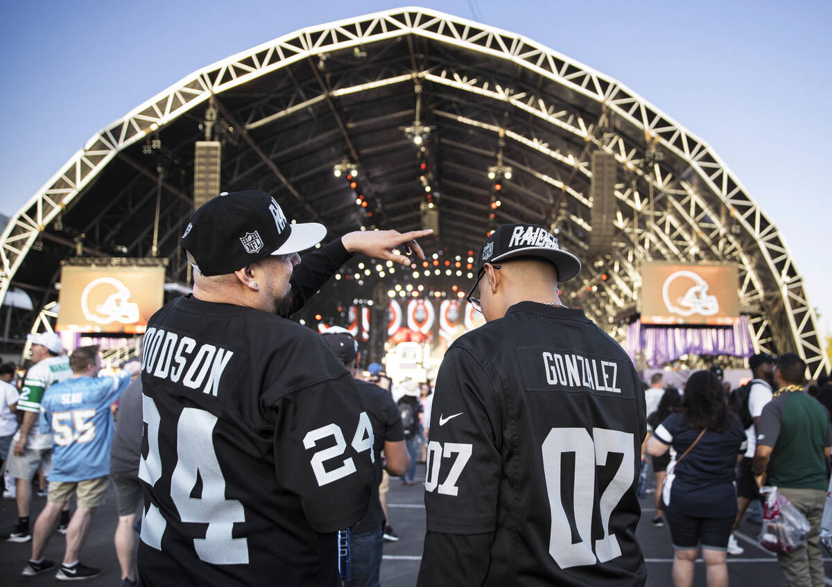 Raiders fans outside the NFL Draft Stage watch selections being made during day two of the NFL ...