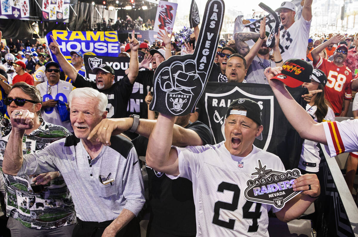 Kevin Armstrong, right, from Garland, Maine, cheers with a large group of Raider fans during da ...