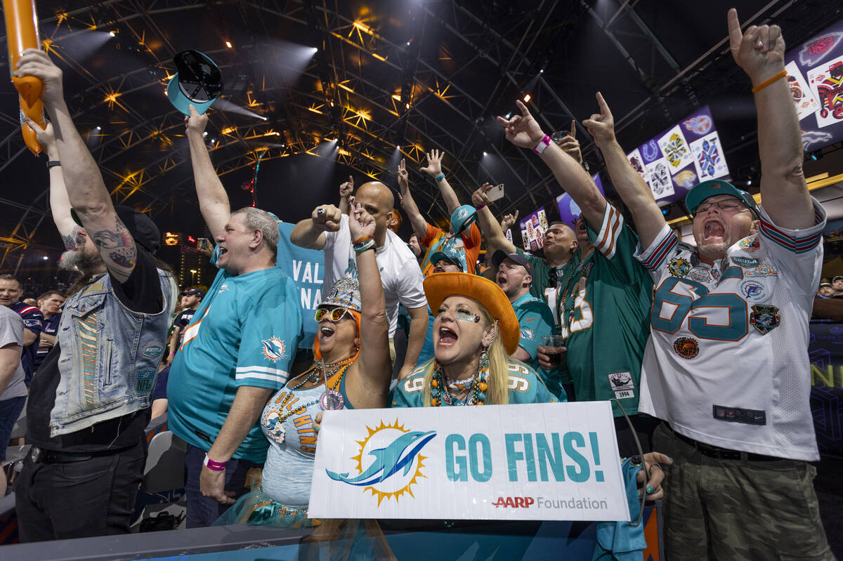 Miami Dolphins fans cheer as a selection for the team is announced at the Draft Theater during ...