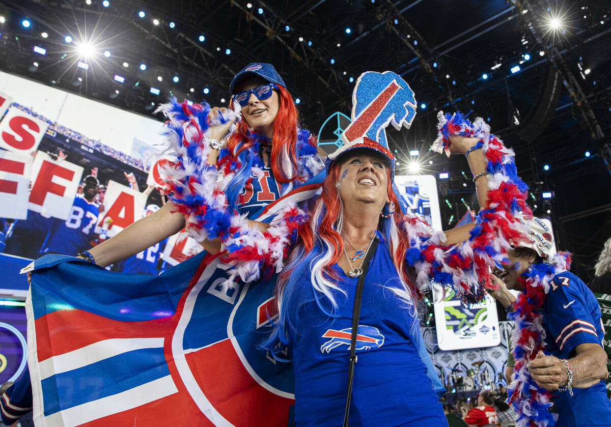Bills fans Cheryl Barber, bottom, and Angela Ferguson, from Las Vegas, during day two of the NF ...