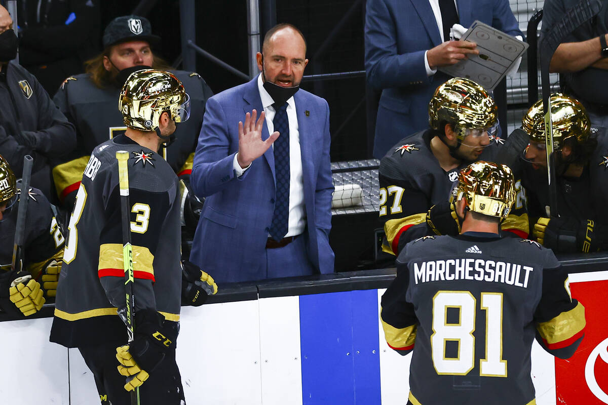 Golden Knights head coach Pete DeBoer talks with his team during the third period of an NHL hoc ...