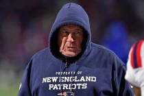 New England Patriots head coach Bill Belichick walks the sideline during the first half of an N ...