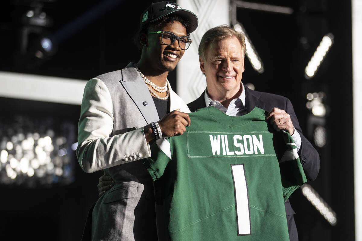 Ohio State wide receiver Garrett Wilson stands with NFL Commissioner Roger Goodell after being ...