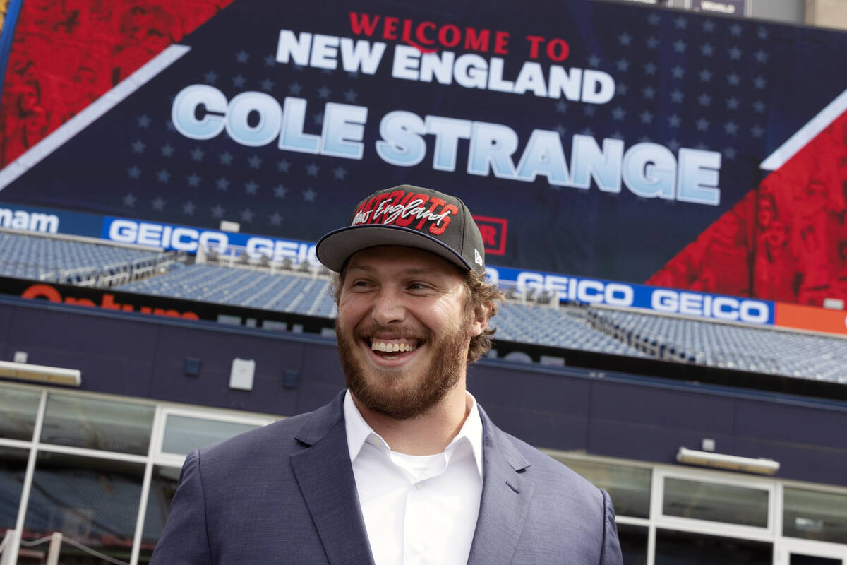 New England Patriots NFL football first-round draft pick offensive linesman Cole Strange smiles ...