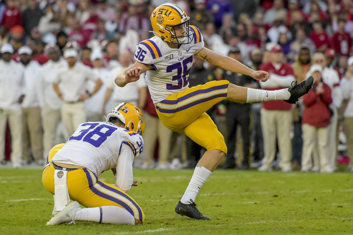 FILE - LSU kicker Cade York (36) kicks an extra point with punter Zach Von Rosenberg (38) holdi ...