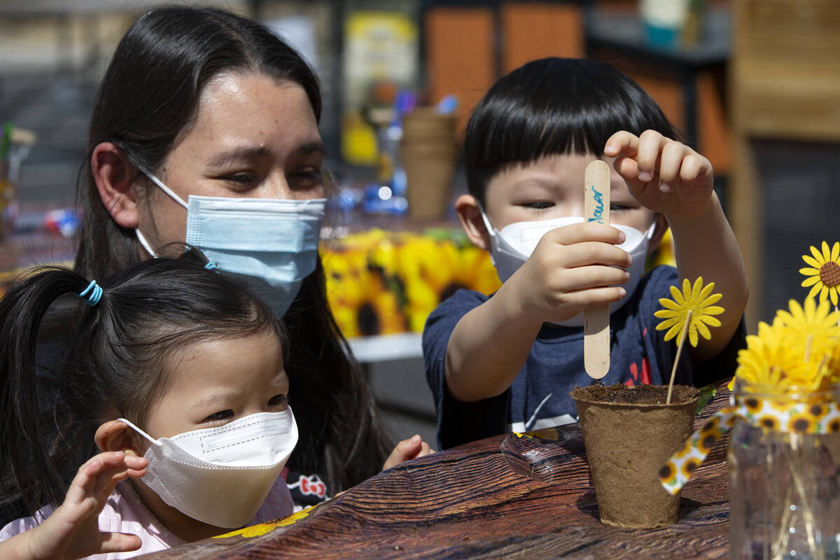 Kayla Gillette, 2, left, her mom Jamie Gillette and her brother Leo Gillette, 4, learn how to p ...