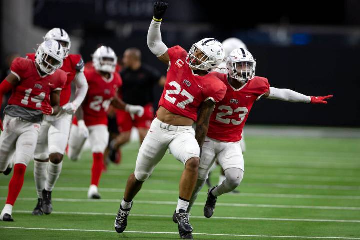 UNLV Rebels linebacker Austin Ajiake (27) and defensive back Jerrae Williams (23) celebrate aft ...