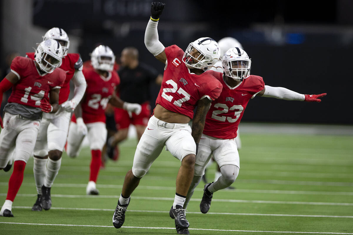 UNLV Rebels linebacker Austin Ajiake (27) and defensive back Jerrae Williams (23) celebrate aft ...