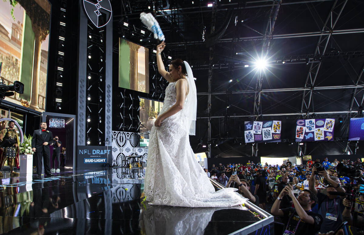 New Orleans Saints fan Briana McAllister tosses her bouquet into the crowd after her onstage we ...