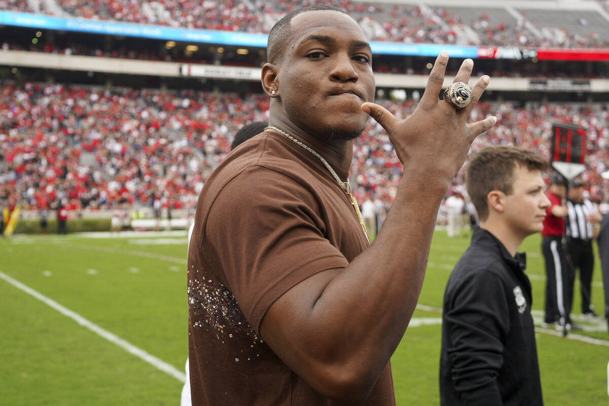 Former Georgia running back Zamir White holds up his National Championship ring in the first ha ...