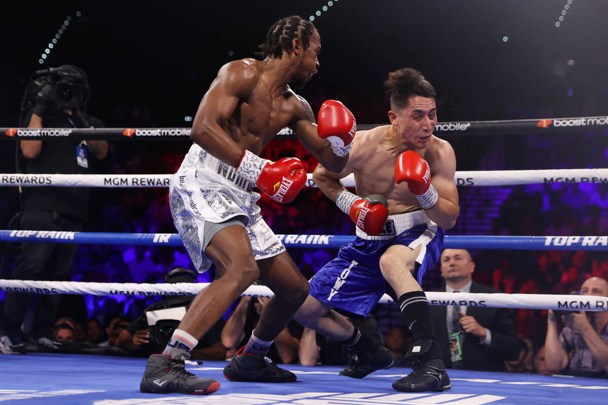 Keyshawn Davis, left, connects a punch against Esteban Sanchez in the third round of a lightwei ...