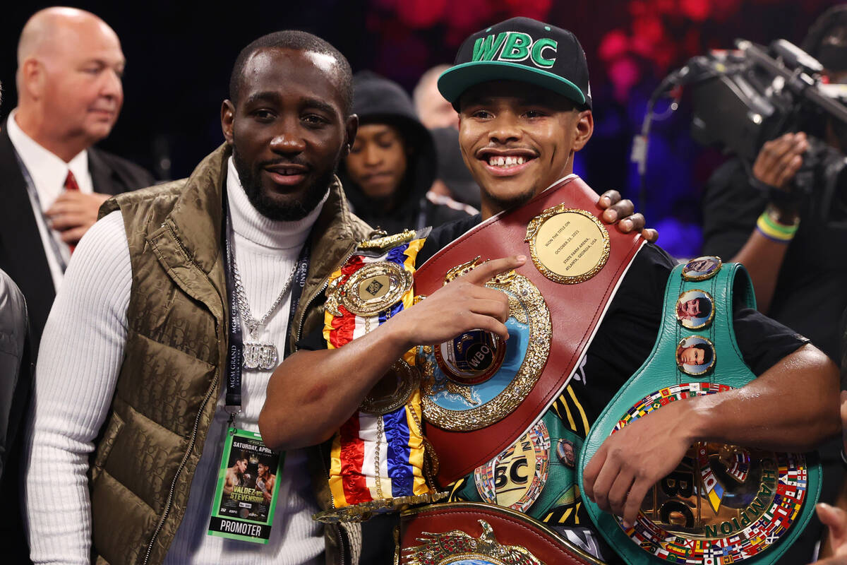 Shakur Stevenson, right, poses with a photo with Terence Crawford after his win against Oscar V ...