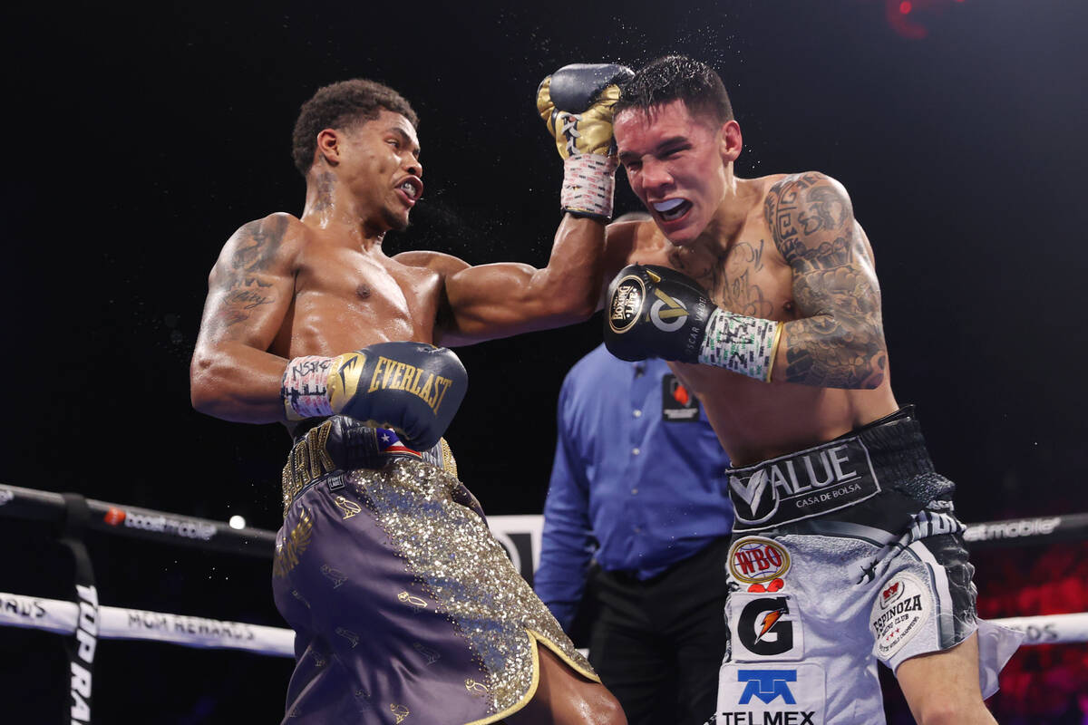 Shakur Stevenson, left, connects a punch against Oscar Valdez in the sixth round of the WBC and ...
